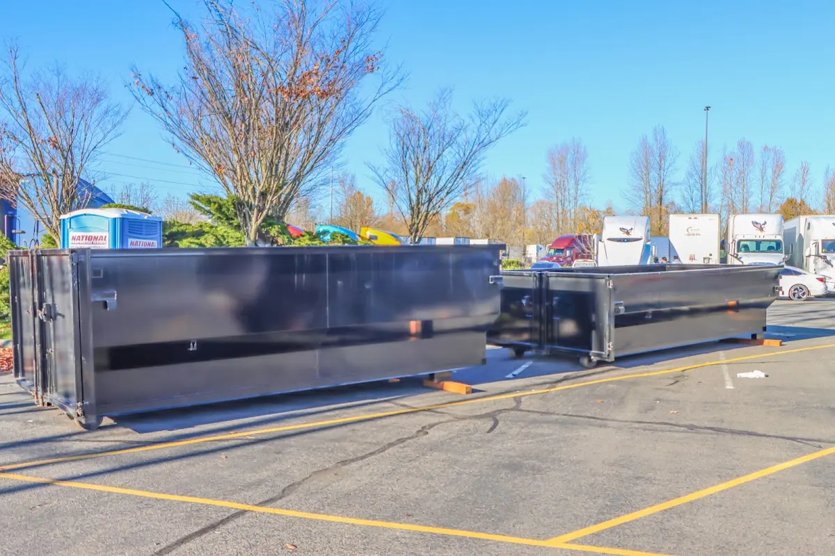 Professional dumpster rental service with roll-off container on residential driveway in Stockbridge